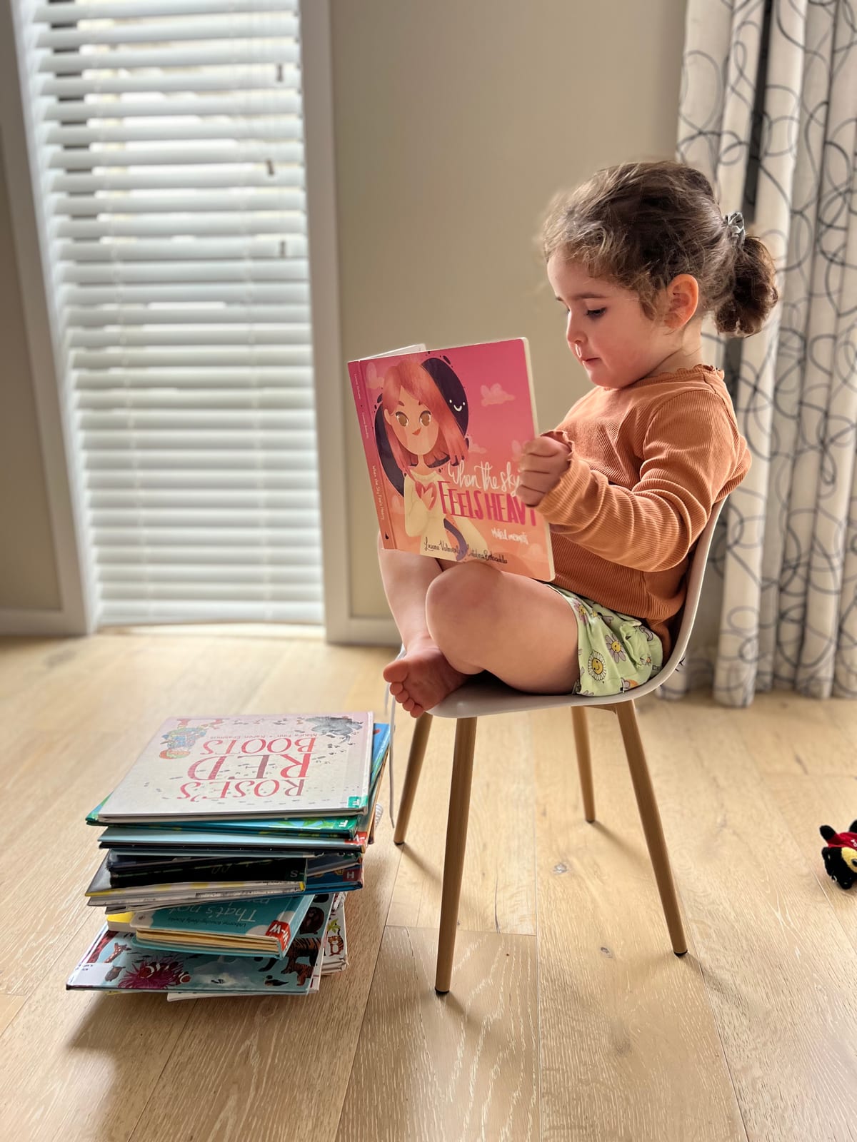 A child reading the book in a chair